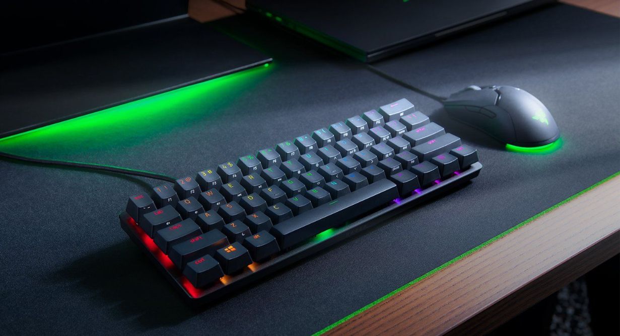 teclado en escritorio junto a un mouse Razer